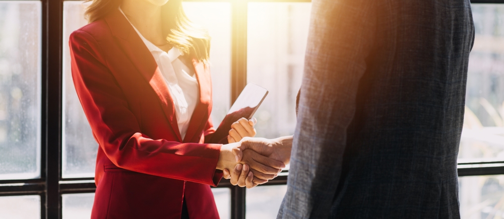 Business owners shaking hands on a merger agreement